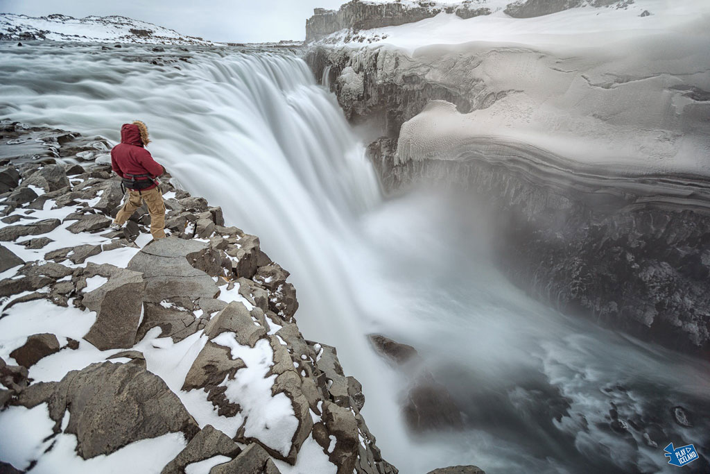 Man standing close to Dettifoss waterfall East Iceland