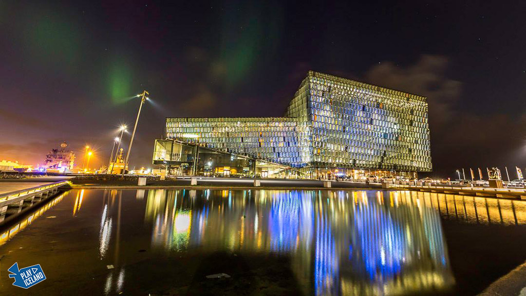 Harpa musichall Reykjavik Iceland with Norterhn lights above