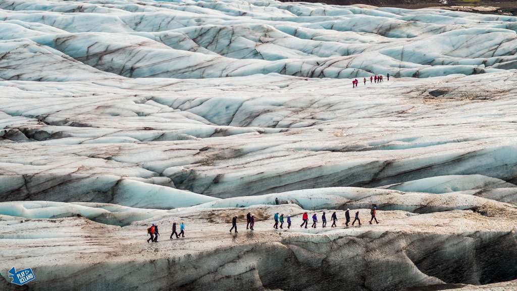 People glacier walking on Solheimajokull glacier in South of Iceland