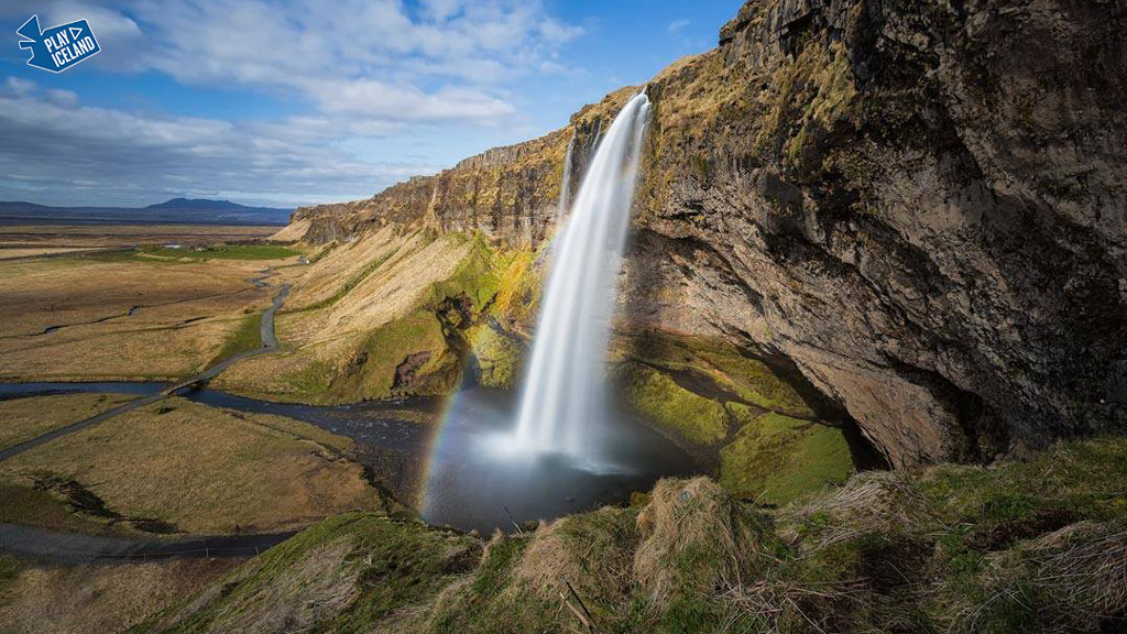 Seljalandsfoss waterfall in South of Iceland with rainbow